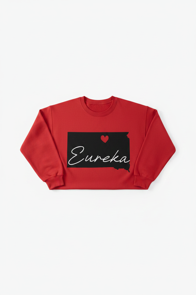 Red crewneck sweatshirt with black South Dakota state silhouette, red heart, and white Eureka cursive script